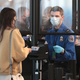 A Transportation Security Administration (TSA) agent screens an airline passenger at O’Hare International Airport on October 19, 2020 in Chicago, Illinois.